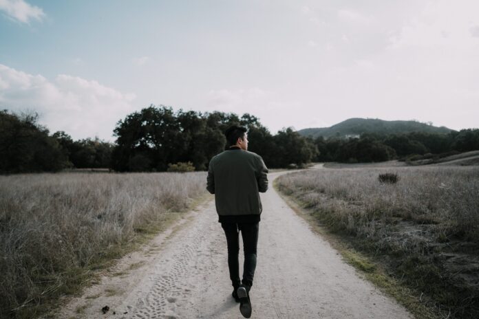 Photo by Francisco Gonzalez man walking on empty road