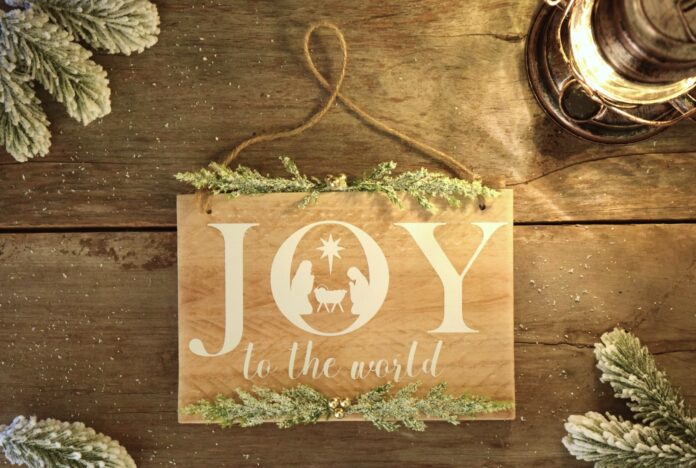 a wooden sign that says joy to the world