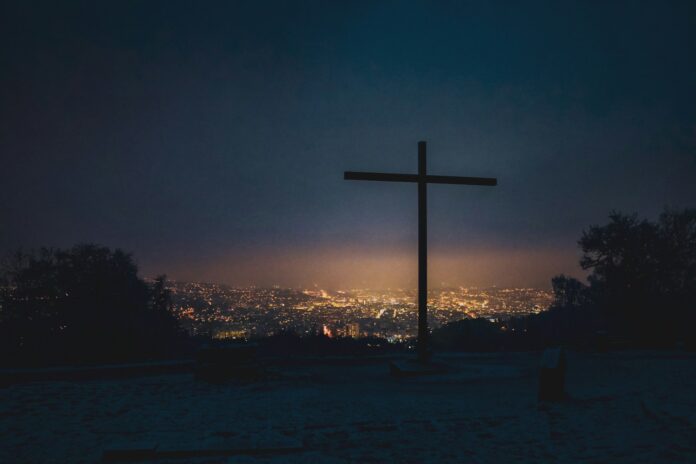 silhouette of cross during sunset