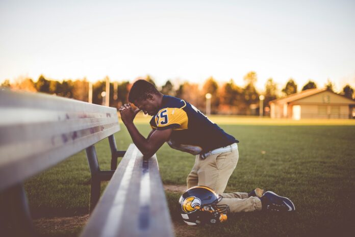 Photo by Ben White baseball player kneeling on ground