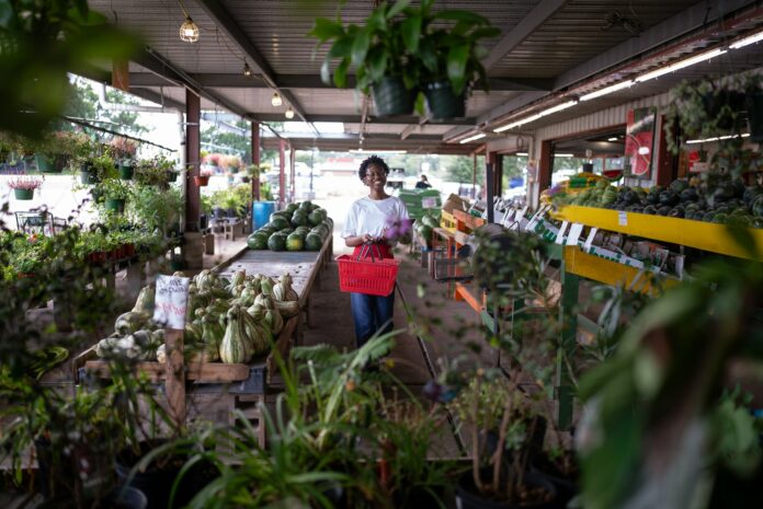 Photo by Land O'Lakes, Inc. Woman shopping at a plant nursery with a basket