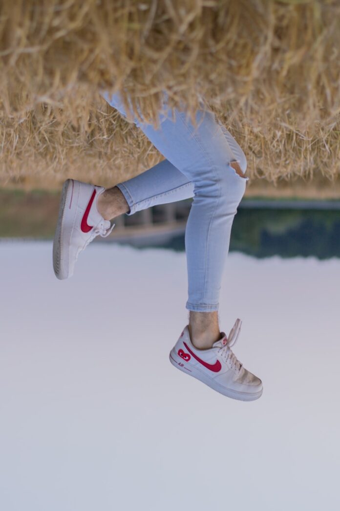 Photo by Filip Baotić person in blue denim jeans and black and white nike sneakers
