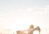 A alegria de Deus person in white sport shirt on shore during golden hour