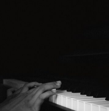 Dó person playing piano in grayscale photography