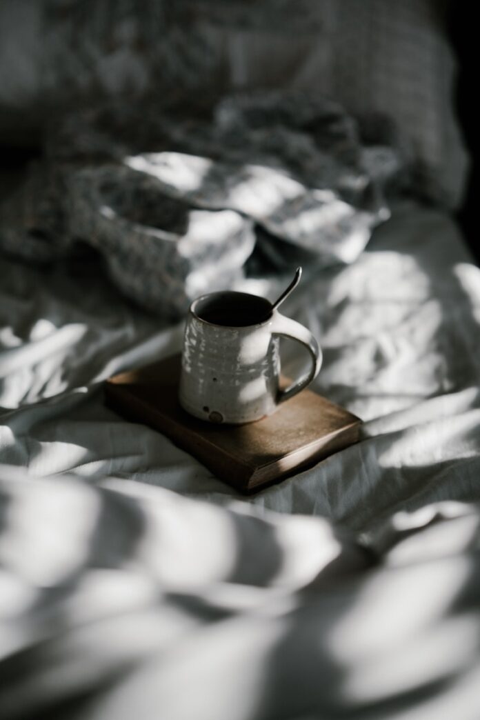 Photo by Annie Spratt white enamel cup on brown book