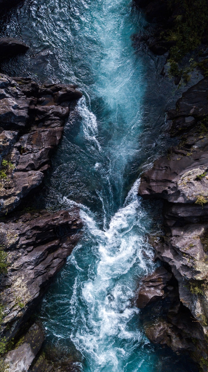 Photo by Joris Visser water falls on rocky mountain