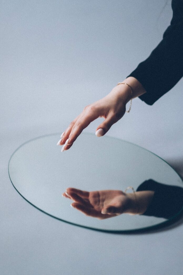 Photo by Михаил Секацкий person in black long sleeve shirt holding round glass