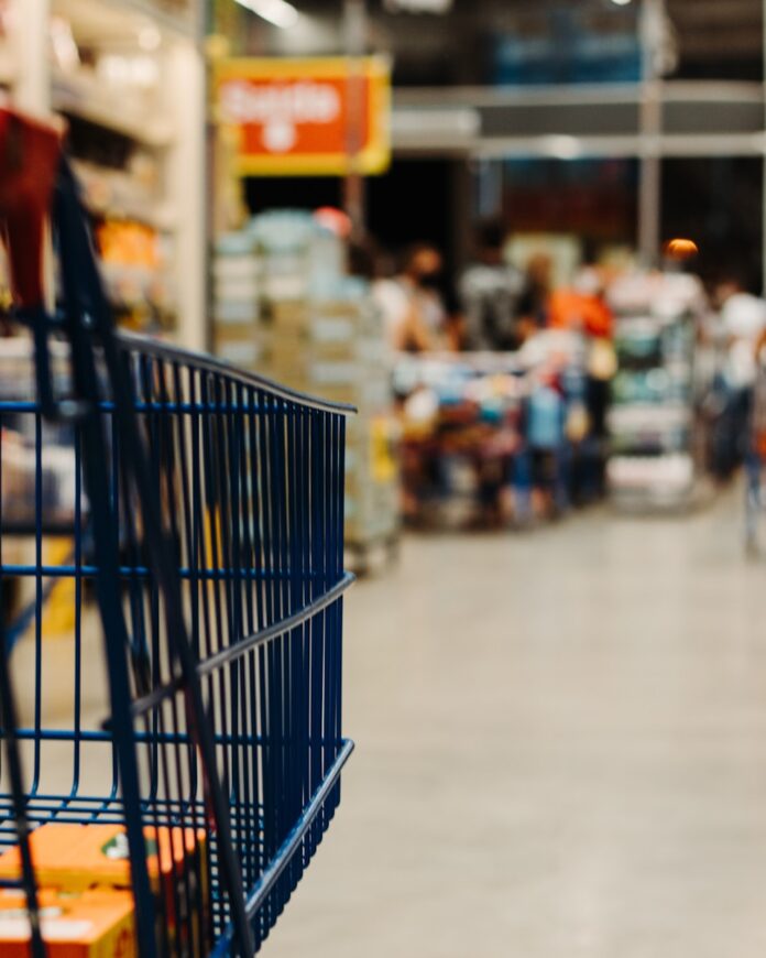 Photo by Eduardo Soares blue shopping cart on street during daytime