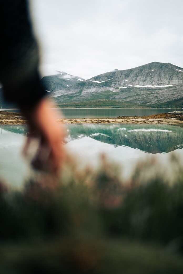 a body of water with mountains in the background