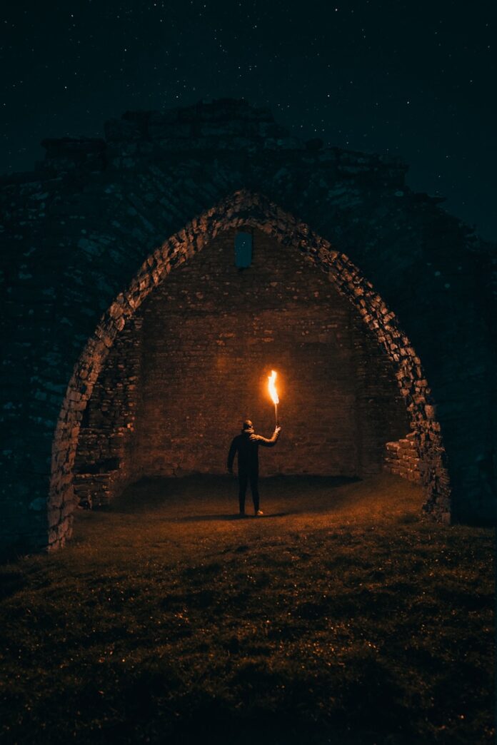 Photo by Linus Sandvide person holding torch in building interior