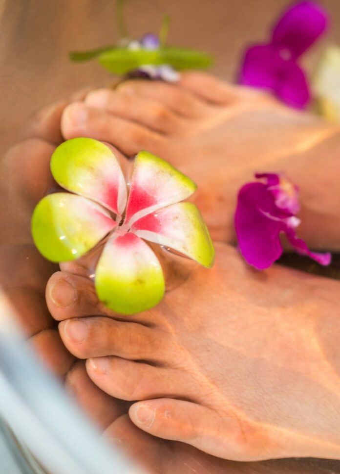 Photo by Rune Enstad person's feet with flowers