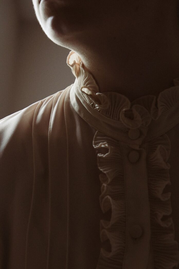 Photo by sombre a close up of a person wearing a dress