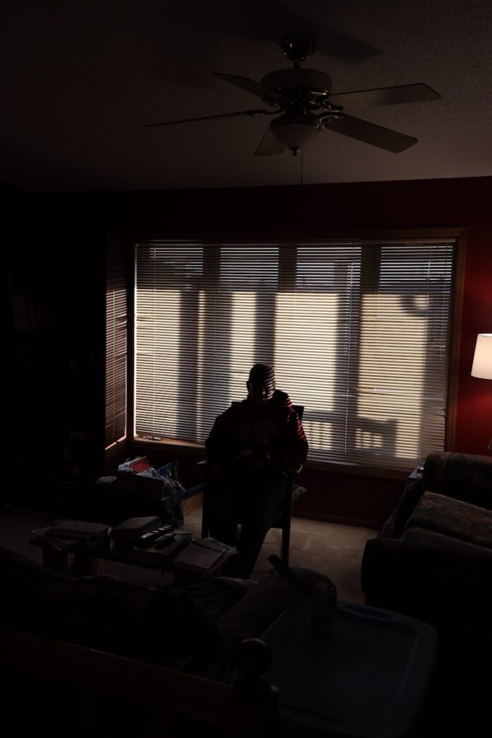 Photo by benjamin hershey woman in black jacket standing near window