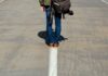 Superando o passado person standing on arrow sign on road