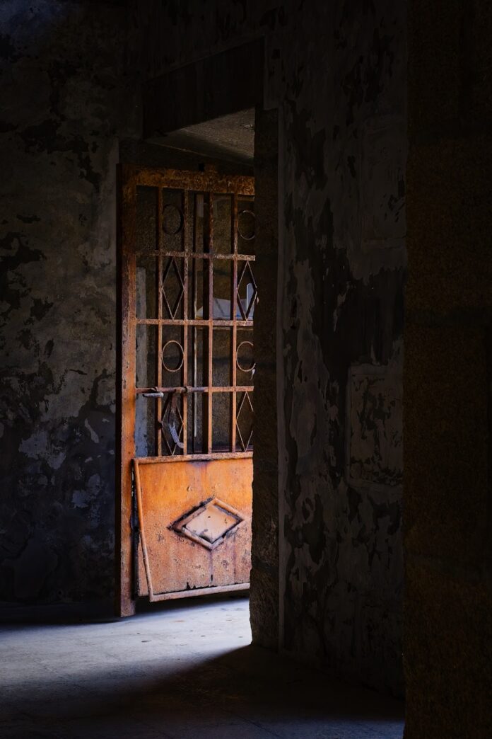 Photo by Eric Prouzet an open door in a dark room with a window