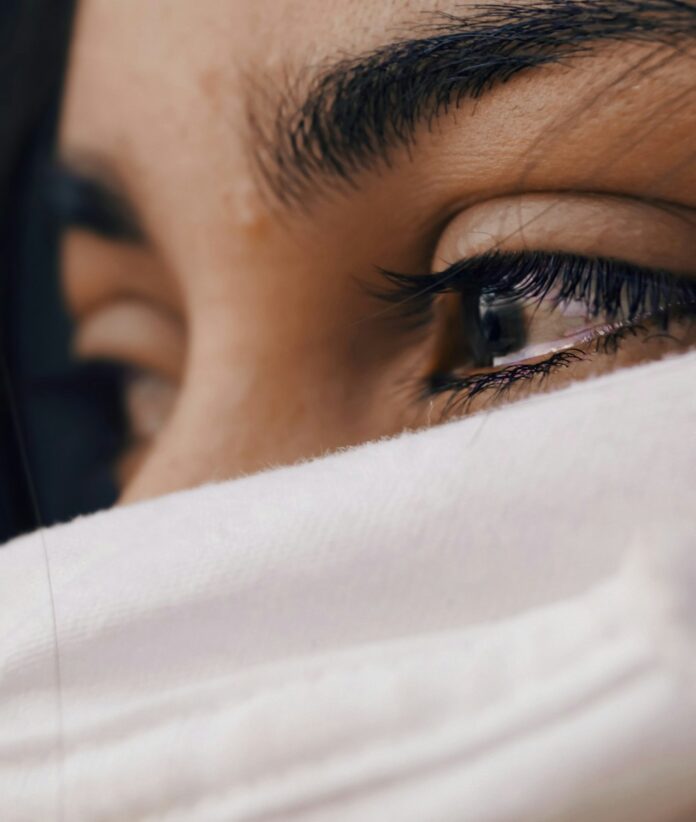 Photo by Louis Galvez shallow focus of a woman's sad eyes