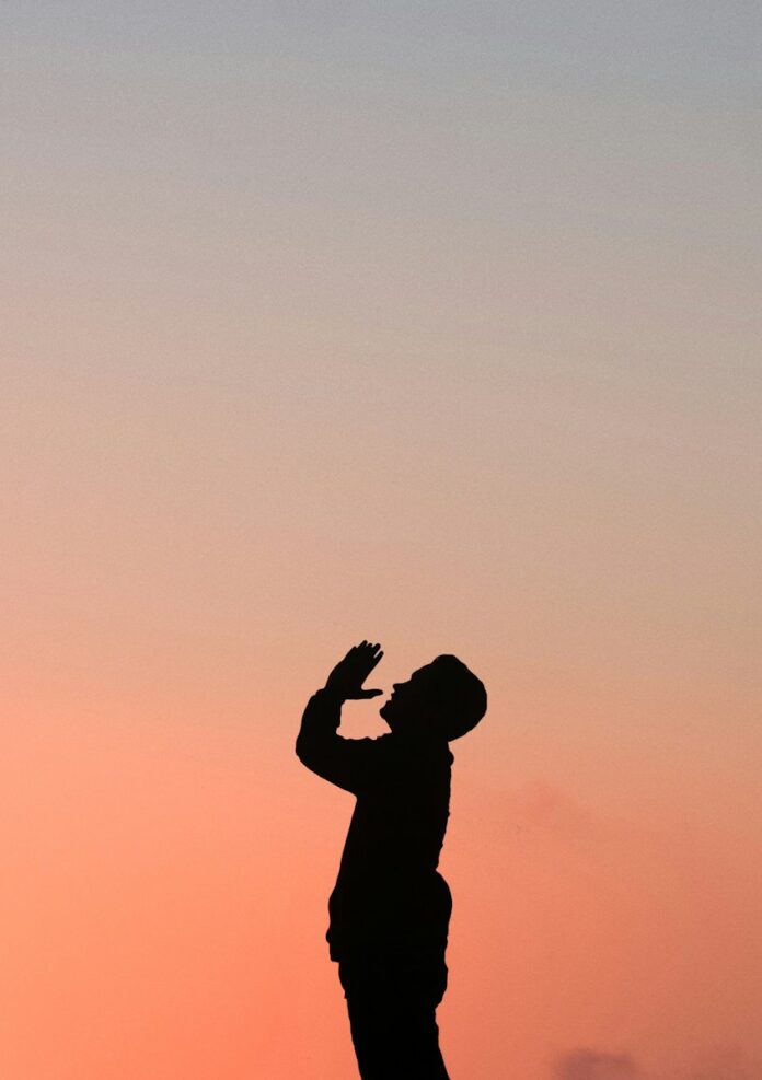 Photo by nega silhouette of man during golden hour